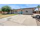 Charming single-story home with a long driveway, mature tree, and plenty of parking space at 5615 W Camelback Rd, Phoenix, AZ 85031