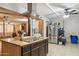 Kitchen with island cooktop, stainless steel refrigerator, and an open layout for easy entertaining at 5615 W Camelback Rd, Phoenix, AZ 85031