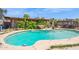Inviting backyard pool surrounded by lush greenery and a shaded pergola, perfect for relaxation at 5615 W Camelback Rd, Phoenix, AZ 85031