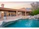 Stunning backyard oasis with a pool, waterfall, and expansive patio for entertaining at 5921 E Leisure Ln, Carefree, AZ 85377