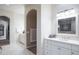 Elegant bathroom with white cabinetry, arched doorways, and tile flooring at 5921 E Leisure Ln, Carefree, AZ 85377