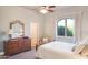 Inviting bedroom with a dresser, large window, and soft, neutral tones at 5921 E Leisure Ln, Carefree, AZ 85377