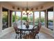 Charming dining area with bay windows overlooking lush landscaping and a relaxing pool area at 5921 E Leisure Ln, Carefree, AZ 85377