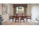 Formal dining room with a wooden table, upholstered chairs, elegant curtains, and natural lighting at 5921 E Leisure Ln, Carefree, AZ 85377