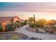 Charming home with a desert landscape, tiled roof, and sunlit driveway, perfect for tranquil living at 5921 E Leisure Ln, Carefree, AZ 85377