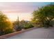 Picturesque desert landscape with distant mountain views and a glimpse of the home at 5921 E Leisure Ln, Carefree, AZ 85377