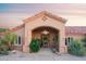 Inviting home entrance with a grand arched portico and attractive desert landscaping at 5921 E Leisure Ln, Carefree, AZ 85377