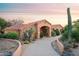 Charming Southwestern home with a terracotta tile roof and lush desert landscaping at 5921 E Leisure Ln, Carefree, AZ 85377