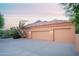 Attached two-car garage with tile roof and desert plants at 5921 E Leisure Ln, Carefree, AZ 85377