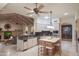 Open-concept kitchen flows into the living room and features granite counters, an island, and stainless steel appliances at 5921 E Leisure Ln, Carefree, AZ 85377