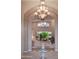 Elegant living room with high ceilings, a chandelier, and seamless access to the outdoor living area at 5921 E Leisure Ln, Carefree, AZ 85377