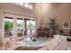 Cozy living room featuring an entertainment piano, plush seating, and an open view to the outdoor pool area at 5921 E Leisure Ln, Carefree, AZ 85377