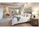 Serene main bedroom featuring a cozy fireplace, access to a private patio, and a comfortable king-size bed at 5921 E Leisure Ln, Carefree, AZ 85377