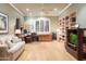 Bright home office with built-in bookshelves, a comfortable sofa, and a large window at 5921 E Leisure Ln, Carefree, AZ 85377