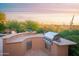 Built-in outdoor grill with a counter and picturesque desert scenery at 5921 E Leisure Ln, Carefree, AZ 85377