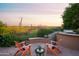Outdoor seating area with desert views and a built-in grill at 5921 E Leisure Ln, Carefree, AZ 85377