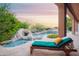 Inviting backyard featuring a pool with a waterfall and lush desert landscaping at 5921 E Leisure Ln, Carefree, AZ 85377
