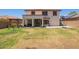 A large backyard with a covered patio and green lawn at 597 S 221St Dr, Buckeye, AZ 85326