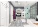 Bathroom with decorative tile flooring, glass shower, and storage cabinets at 597 S 221St Dr, Buckeye, AZ 85326