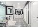 A sleek bathroom featuring white cabinets, decorative tile flooring, and modern fixtures at 597 S 221St Dr, Buckeye, AZ 85326