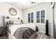 Cozy bedroom features modern gray color scheme, stylish decor, and natural light at 597 S 221St Dr, Buckeye, AZ 85326