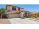 Inviting two-story home featuring a two-car garage and desert landscaping at 597 S 221St Dr, Buckeye, AZ 85326