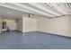 Spacious garage featuring a gray epoxy floor and ample room for storage and parking at 597 S 221St Dr, Buckeye, AZ 85326