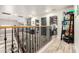 Upstairs hallway with wood flooring and access to various rooms. Perfect for a busy Gathering at 597 S 221St Dr, Buckeye, AZ 85326