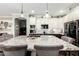 A modern kitchen with a large island, granite countertops, and stylish pendant lighting above the island at 597 S 221St Dr, Buckeye, AZ 85326