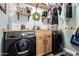 Laundry room with a washer and dryer, wood cabinets, and shelving at 597 S 221St Dr, Buckeye, AZ 85326