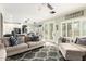 Comfortable living room featuring a cozy sofa, decorative pillows, and a seamless transition to the outdoor space at 597 S 221St Dr, Buckeye, AZ 85326