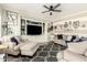 Cozy living room with comfortable seating, a large entertainment center, and modern decor accents at 597 S 221St Dr, Buckeye, AZ 85326