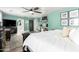 Bright main bedroom with wood flooring and views of a makeup vanity and ensuite bathroom at 597 S 221St Dr, Buckeye, AZ 85326