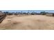 Wide shot of backyard with dirt ground, perimeter fencing, a house, and sheds at 6104 W Marconi Ave, Glendale, AZ 85306