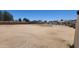 Fenced backyard with dirt ground and perimeter fencing under a blue sky at 6104 W Marconi Ave, Glendale, AZ 85306