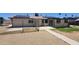 Backyard with a small concrete patio area and solar panels on the roof for energy efficiency at 6104 W Marconi Ave, Glendale, AZ 85306