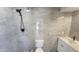Updated bathroom features tiled walk-in shower, stone floor, and modern vanity at 6104 W Marconi Ave, Glendale, AZ 85306