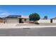 Single-story home with a well-manicured front yard featuring desert landscaping and solar panels at 6104 W Marconi Ave, Glendale, AZ 85306