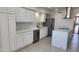 Modern kitchen with white cabinets, stainless steel appliances, quartz countertops, and an island at 6104 W Marconi Ave, Glendale, AZ 85306