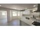 Modern kitchen with white cabinets, a quartz countertop island, and stainless-steel appliances at 6104 W Marconi Ave, Glendale, AZ 85306