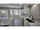 Open kitchen area with island, quartz counters, white cabinets, tile floor, and recessed lights at 6104 W Marconi Ave, Glendale, AZ 85306