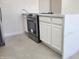 Kitchen island with white cabinets, quartz countertop, stainless steel oven and tile flooring at 6104 W Marconi Ave, Glendale, AZ 85306