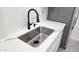 Modern kitchen sink featuring quartz countertops, stainless steel basin, and matte black faucet at 6104 W Marconi Ave, Glendale, AZ 85306