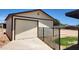 Backyard shed with a roll-up door, side door, and surrounded by a chain-link fence at 6104 W Marconi Ave, Glendale, AZ 85306