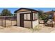 Backyard shed with a side door, window, and utility hookups at 6104 W Marconi Ave, Glendale, AZ 85306