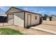Backyard shed with a roll-up door, side door, and a small window at 6104 W Marconi Ave, Glendale, AZ 85306