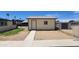 Backyard shed with a side door, a small window, and surrounded by desert landscaping at 6104 W Marconi Ave, Glendale, AZ 85306