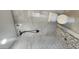 Tiled shower features stone pebble flooring and stone-look tiled walls with modern shower head at 6104 W Marconi Ave, Glendale, AZ 85306