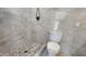 Contemporary bathroom with a walk-in shower featuring stone pebble flooring and stone-look tile walls at 6104 W Marconi Ave, Glendale, AZ 85306