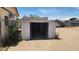 Outdoor storage shed with an open doorway under a blue sky on a sunny day at 6104 W Marconi Ave, Glendale, AZ 85306